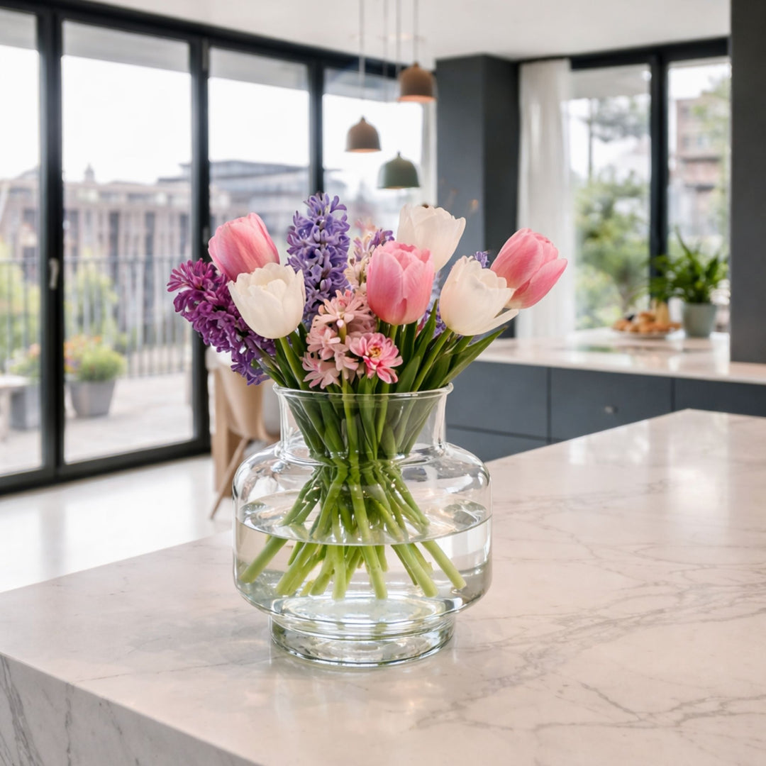 Clear glass vase with water and fresh flowers in modern home interior